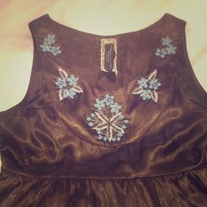 Sleeveless empire-waist beaded blouse